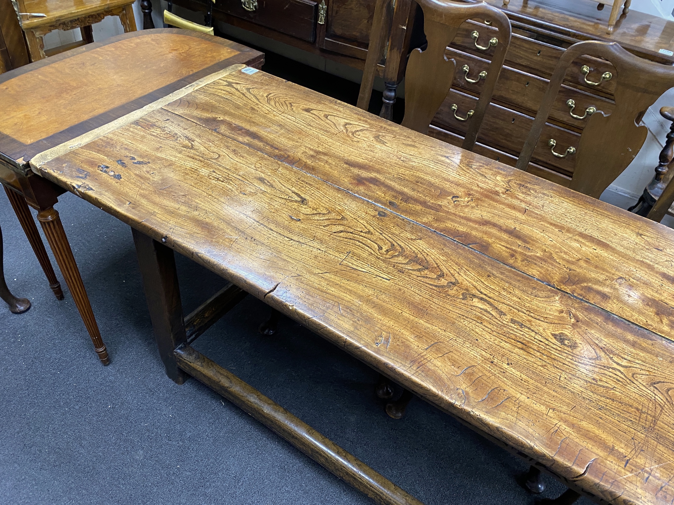 A late 17th / early 18th century elm two plank top refectory table (re-cleated), length 186cm, depth 70cm, height 76cm